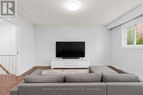 Toronto (O'connor-Parkview) townhouse for rent - A living room with a grey couch and a white television stand.