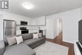 Toronto (O'connor-Parkview) townhouse for rent - A modern living room with a grey couch and a flat screen TV.