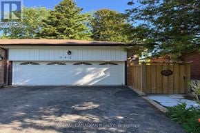 Toronto (West Hill) apartment for rent - A garage with a white door and a brown fence.
