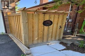 Toronto (West Hill) apartment for rent - A wooden fence with a circular metal plate on it.