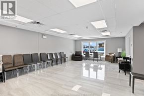 Tecumseh condo for rent - A waiting room with chairs and a table with a plant on it.