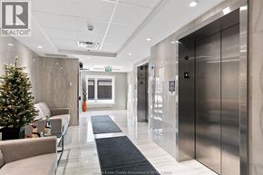 Tecumseh condo for rent - A modern office lobby with a Christmas tree and a staircase.