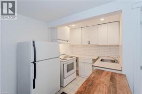 Guelph apartment for rent - A kitchen with white appliances and a wooden counter top.