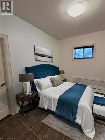 Hamilton apartment for rent - A bedroom with a bed, nightstand, and lamp.