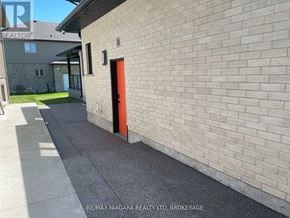 Niagara Falls (Oldfield) apartment for rent - A building with a red door is shown in the image.