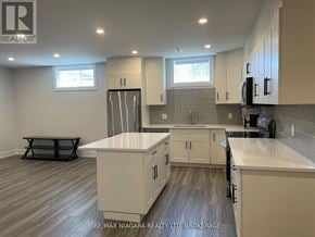 Niagara Falls (Oldfield) apartment for rent - A kitchen with white cabinets and a large island.