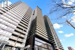 Toronto (Church-Yonge Corridor) condo for rent - A tall building with a unique design featuring a combination of glass and dark-colored panels.