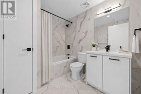 Toronto (Moss Park) condo for rent - A white bathroom with a marble wall and a white toilet.