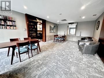 Toronto (Bayview Village) condo for rent - A living room with a grey carpet and wooden furniture.