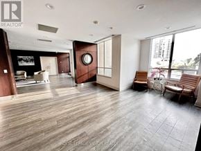 Toronto (Bayview Village) condo for rent - A spacious living room with wood flooring and a large window.
