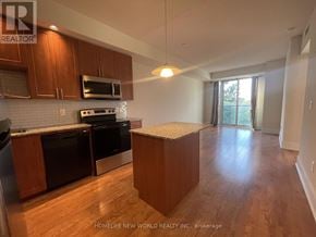 Toronto (Banbury-Don Mills) condo for rent - A kitchen with wooden cabinets and a white countertop.