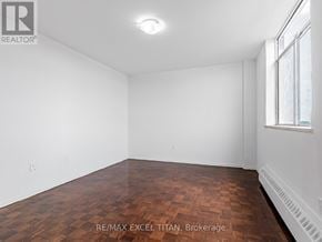 Toronto (Weston) condo for rent - Empty room with wooden floor and white walls.