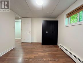 St. Catharines (Burleigh Hill) apartment for rent - A room with a white door and a black wardrobe.