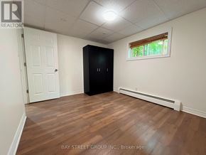 St. Catharines (Burleigh Hill) apartment for rent - A room with a black wardrobe and a window with blinds.
