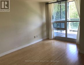 Toronto (Niagara) condo for rent - A room with wooden flooring and a sliding glass door leading to a balcony.