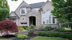 Mississauga (Lorne Park) apartment for rent - A large, well-maintained house with a stone facade and a large front yard.