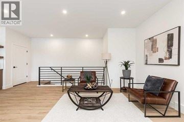 Lethbridge apartment for rent - A living room with a brown leather chair and a white rug.