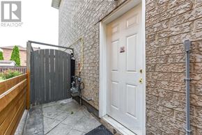 Brampton (Fletcher's Creek Village) apartment for rent - A white door is on the right side of a brick wall.