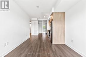 Toronto (Humber Heights) condo for rent - A spacious room with wooden flooring and white walls.