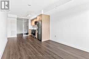 Toronto (Humber Heights) condo for rent - A spacious kitchen with wooden flooring and white walls.