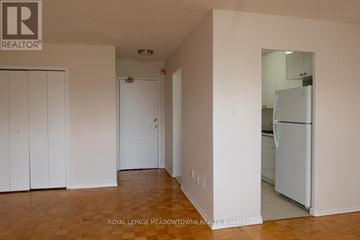 Mississauga (Port Credit) multi-family for rent - A white refrigerator is in the corner of a kitchen.