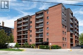 Mississauga (Port Credit) multi-family for rent - A large brick building with a sign that says Royal LePage Meadowtown Realty Brokerage.