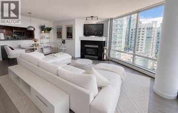 Vancouver apartment for rent - A living room with a white couch and a fireplace.