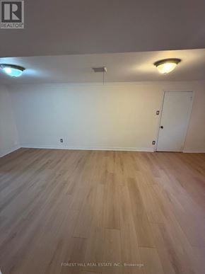 Markham (Thornhill) apartment for rent - A room with wooden flooring and a white door.