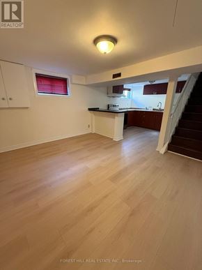 Markham (Thornhill) apartment for rent - A real estate listing image of a kitchen and living room.