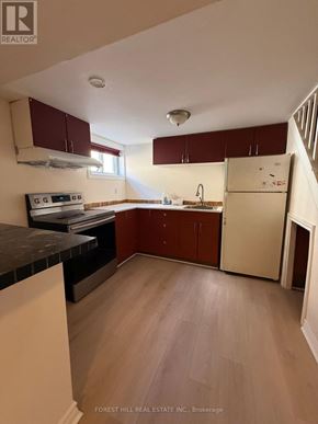 Markham (Thornhill) apartment for rent - A kitchen with wooden floors and white appliances.