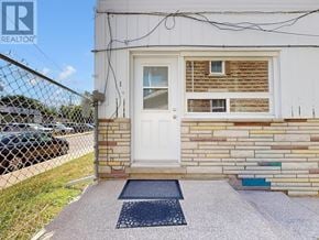 Halton Hills (Georgetown) multi-family for rent - A white door with a window above it and a brick wall below it.