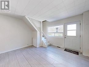 Halton Hills (Georgetown) multi-family for rent - A white room with a staircase leading to the second floor.