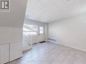 Halton Hills (Georgetown) multi-family for rent - A white room with a window and a door.