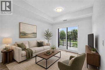 Waterloo condo for rent - A living room with a couch, chair, and a painting on the wall.