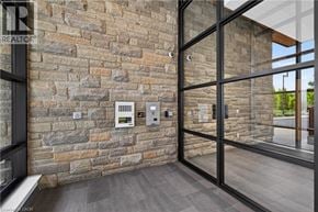 Waterloo condo for rent - A modern interior with a stone wall and glass doors.