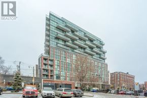 Toronto (Moss Park) condo for rent - A modern multi-story building with a glass facade is the main focus of the image.