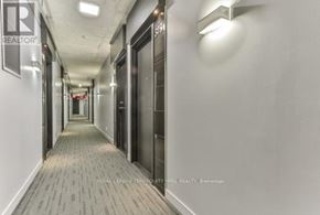 Toronto (Moss Park) condo for rent - A long hallway with doors on both sides and a sign that says REALTOR.