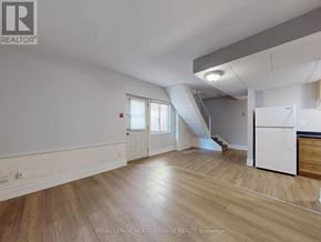 Halton Hills (Georgetown) multi-family for rent - A spacious room with wooden flooring and white walls.