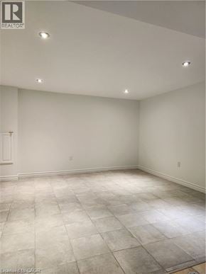 Thorold apartment for rent - A large empty room with a tiled floor and recessed lighting.