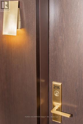 Toronto (Waterfront Communities) condo for rent - A door with a gold handle and a number 2116 on it.
