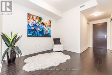 Toronto (Waterfront Communities) condo for rent - A living room with a white rug and a painting on the wall.