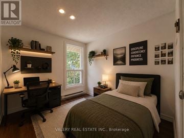 Guelph (Kortright East) apartment for rent - A bedroom with a bed, desk, and a window.