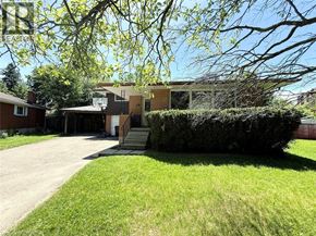 Waterloo apartment for rent - A house with a driveway and a green lawn.