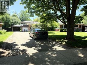 Waterloo apartment for rent - A black car is parked on a driveway in front of a house.