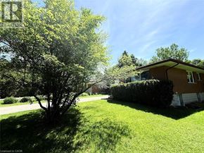 Waterloo apartment for rent - A house with a brown roof and a green lawn in front.