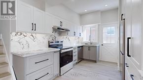 Toronto (Parkwoods-Donalda) apartment for rent - A kitchen with white cabinets and a marble countertop.