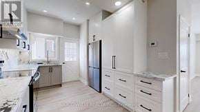 Toronto (Parkwoods-Donalda) apartment for rent - A kitchen with a marble countertop and a refrigerator.