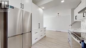 Toronto (Parkwoods-Donalda) apartment for rent - A kitchen with a refrigerator, cabinets, and a counter.