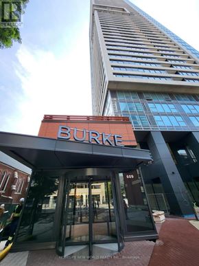 Toronto (North St. James Town) condo for rent - The Burke building is a tall, modern structure with a glass facade.