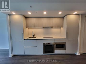 Toronto (North St. James Town) condo for rent - A modern kitchen with white cabinets and stainless steel appliances.